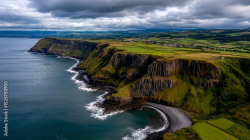Dramatic Aerial View of Coastal Cliffs Green Fields and Ocean Waves