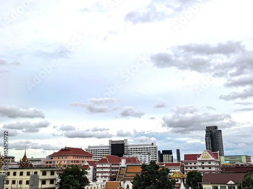 Bangkok Cityscape with Temples and Modern Buildings Under Cloudy Sky
