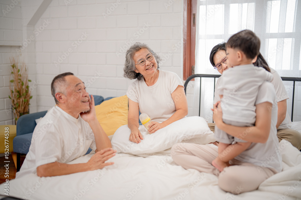 Obraz premium Family gathering in a cozy bedroom with grandparents, parents, and child enjoying quality time together
