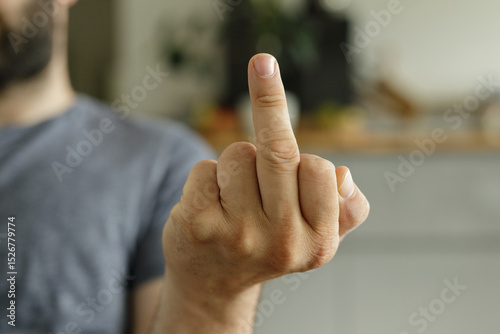 Close-up of a hand giving the middle finger gesture.