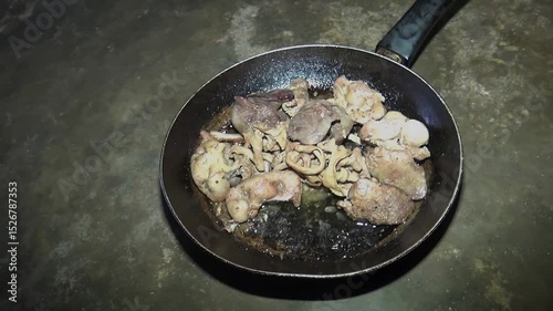Boiled chicken offal in a frying pan on the floor
