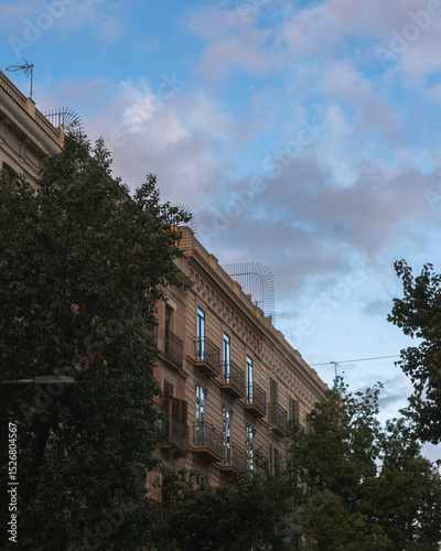 Classic Residential Building with Reflections at Dusk in Eixample, Barcelona