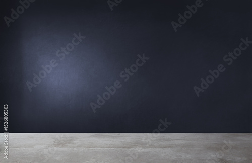 There is an empty room that features a black wall and has a concrete floor
