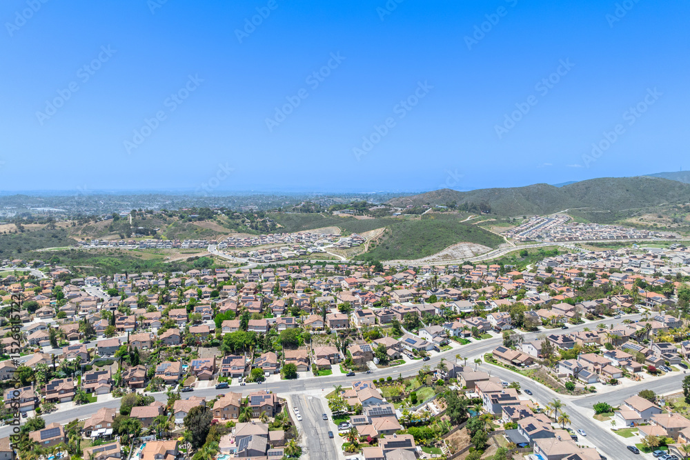 Fototapeta premium Aerial view of San Marcos neighborhood with houses and street during sunny day, South California, USA.