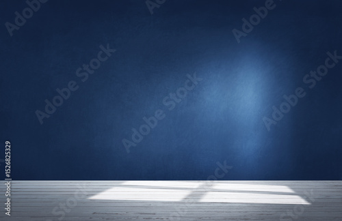 Dark blue wall in an empty room with a concrete floor