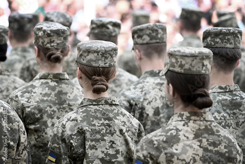 Woman soldier. Woman in army. Ukrainian flag on military uniform. Ukraine troops.