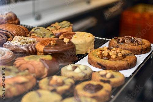 Golden flaky croissants  and  pastry sweets with toppings displayed in a  frech  bakery  at Monaco
Delicious croissants on the store showcase.

