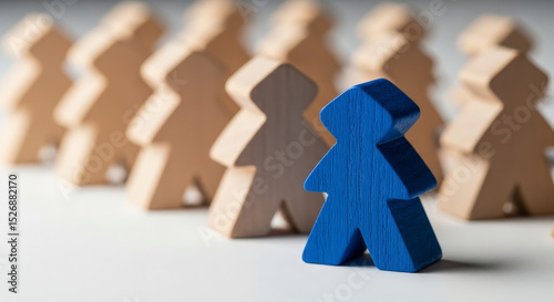 Blue Wooden Figurine Distinct From Group Symbolizing Leadership And Uniqueness Against White Background