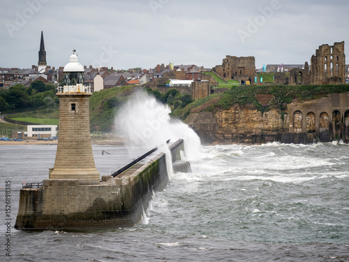 Waves crashing against the breakwater in the mouth of the River Tyne, Newcastle, England