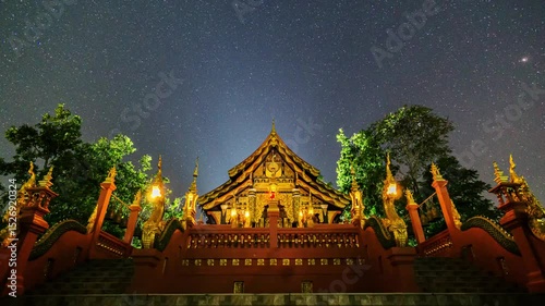 4K timelapse of the night sky above Wat Phra That Doi Phra Chan, Lampang, Thailand. Stars shine above the temple and stupa in a tranquil atmosphere.