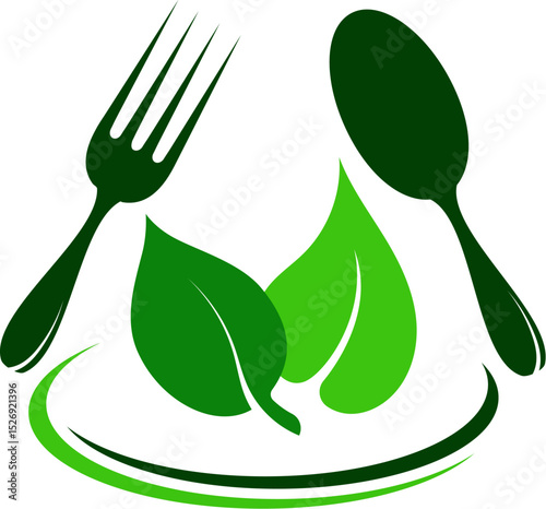 Green leaves in a plate and a fork and spoon. Sign green food, clean food, eco food, vegetarian food