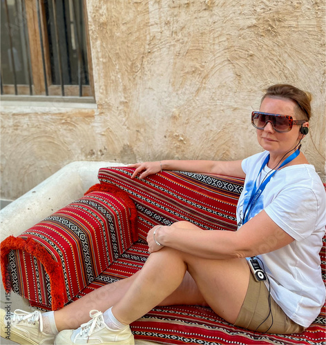 A woman wearing sunglasses poses at the Souk Waqif Market in Doha photo
