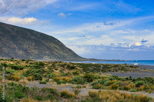The rugged, desolate-looking promontory Turakirae Head, part of the Rimutaka Range, in the remote extreme south of North Island, New Zealand. 

