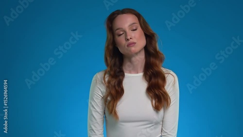 Emotionally expressive woman posing in studio with vibrant backdrop