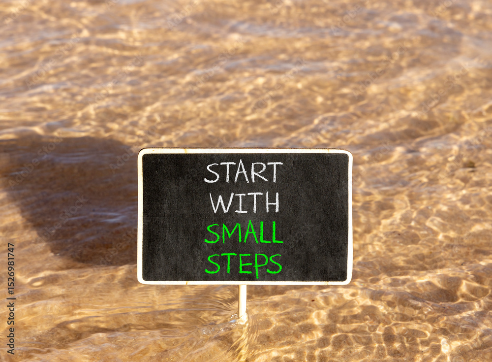 Naklejka premium Start with small steps symbol. Concept words phrase Start with small steps on beautiful black blackboard. Beautiful Red sea water background. Business Start with small steps concept. Copy space.
