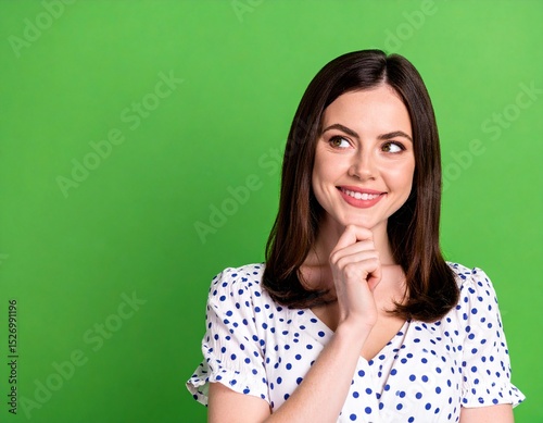 Portrait of Thoughtful Girl in Trendy Dotted Clothes Looking into Empty Space on Colorful Background