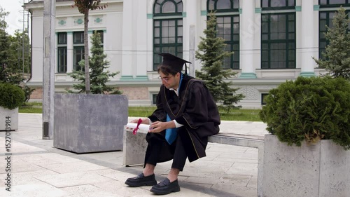 Graduate in robe twists diploma not believing in reality