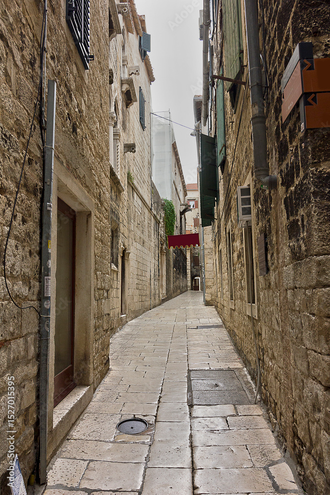 Fototapeta premium narrow street with old stone houses in the historical centre of Split, Croatia