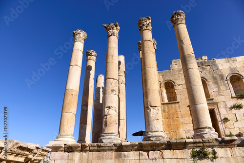 Visitors admire the towering ancient columns of Jerash, also known as Gerasa, surrounded by ruins that reflect the site's rich history and architectural splendor in Jordan. photo