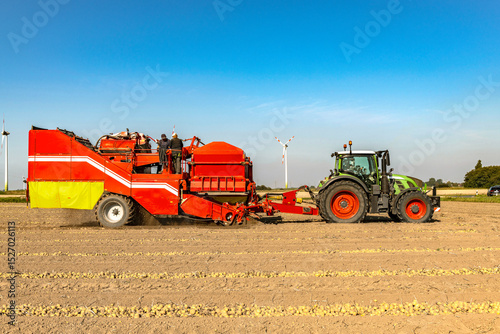 Tractor with potato harvester in the field - 4000