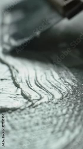 Wallpaper Mural An extreme close-up macro video of a metallic tool smoothly spreading thick, opaque white creamy substance, leaving flowing ridges on a finely textured surface with pleasing bokeh. Detailed lighting Torontodigital.ca