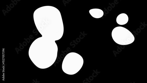 White color spots merging into one on black background. Abstract white shapes merge on dark background