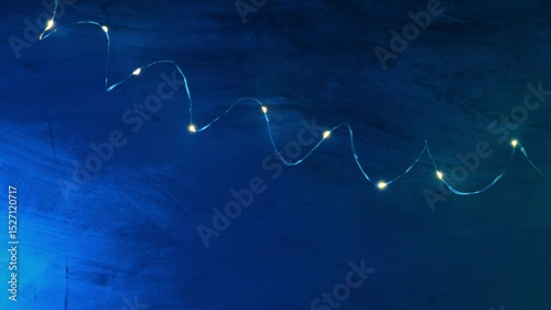Glow background.lights of garlands on a blue background.Christmas Shining texture. 4k footage