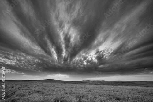 Abstract dramatic black and white landscape of clouds over open prairie land