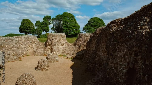 Ruined ramparts, grassy terraces and scattered stone foundations atop the windswept hill, Old Sarum, Salisbury, Wiltshire, England, UK
