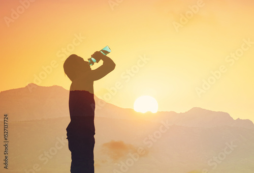 Active man drinking water staying hydrated