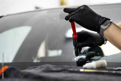Slika na platnu Auto glass technician repairing a windshield crack close-up with precise resin delivery for optimal strength
