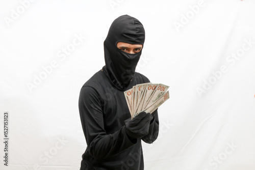 thief holding many dollar bills isolated on white background