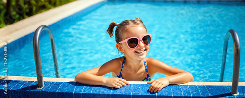 happy kid girl at swimming pool