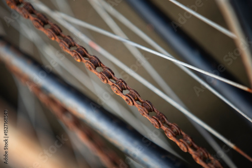 Close up of old rusty bicycle rear wheel and chain, selective focus