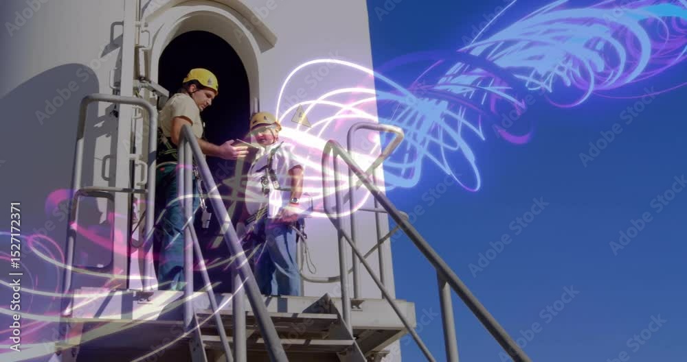 Technicians climbing stairs reviewing tablet data and watching neon streams envelop site for safety