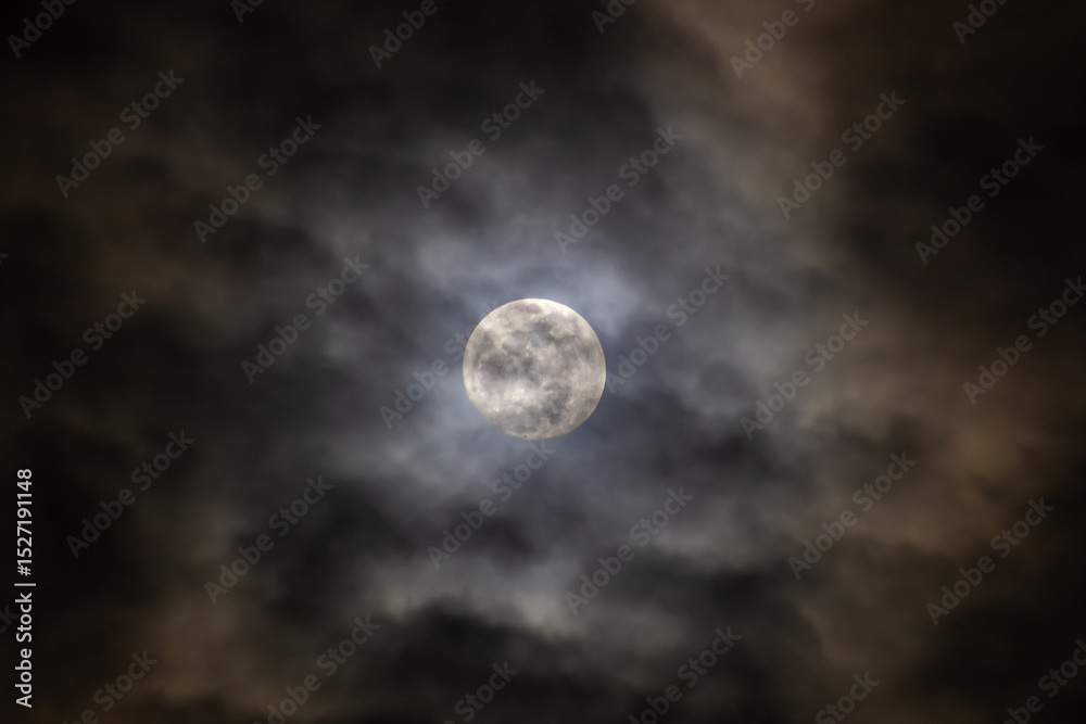 Full moon in the night sky with clouds. Abstract nature background. Full moon in the night sky with clouds. Abstract nature background.