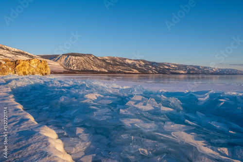 Baikal Lake in winter. Beautiful landscape with mountains reflected in ice of frozen Small Sea