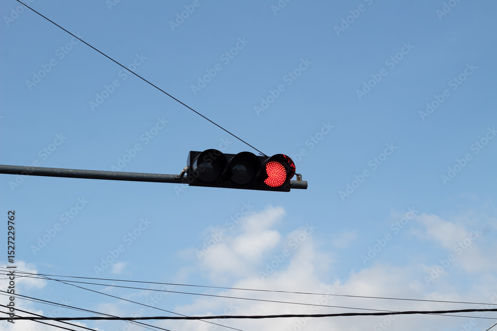 Red Traffic Light Against Blue Sky Red Traffic Light Against Blue Sky
