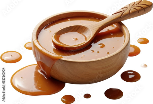 Caramel sauce overflows from wooden bowl with spoon inside