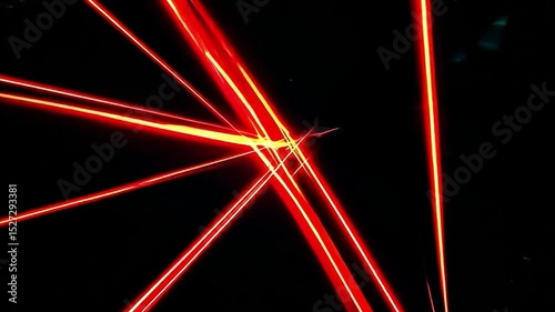Dynamic Red Laser Beams Cutting Through Dark Background Creating Striking Visual Effects