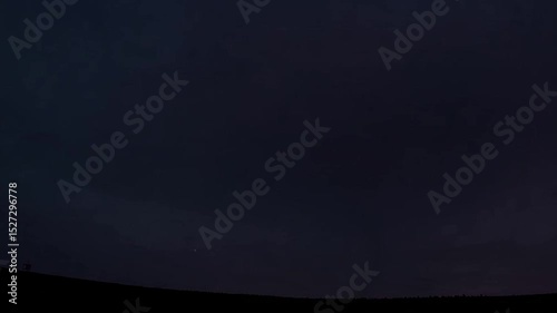 Dramatic Lightning Strike Illuminates Dark Skies Over A Rural Landscape at Nighttime