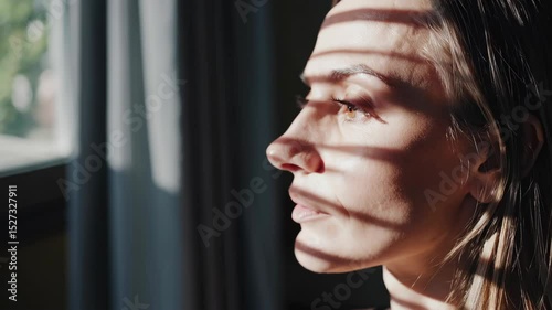 Profile of Young Woman with Shadows and Natural Light in Window