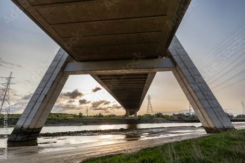 View from beneath the Flintshire Bridge, showcasing its sturdy concrete structure over River Dee at sunrise