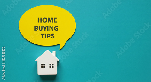 A yellow speech bubble with home buying tips above a small white house on a teal background surface