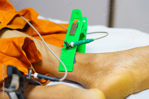 ECG or EKG of man with electrodes for electrocardiogram records on bed in hospital