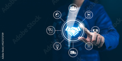 Ecosystem and Partnerships concept. Businessman touching holographic handshake and business and technology icon. Collaboration, digital ecosystem, integrated solutions in modern corporate environment.