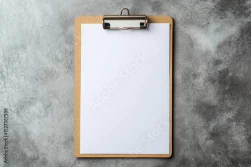 Clipboard with paper on textured grey background