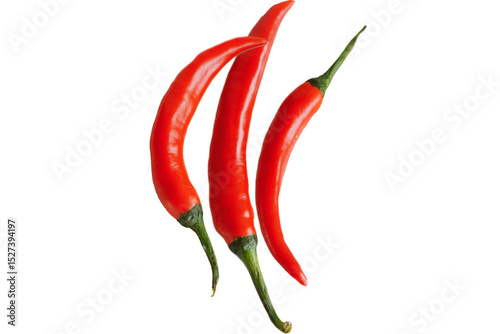 Fototapeta Naklejka Na Ścianę i Meble -  Three vibrant red chili peppers with green stems isolated against a black background image view