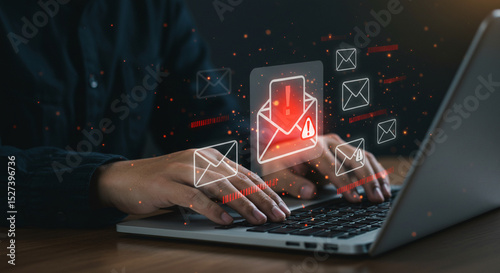 Person typing on a laptop with email icons and alert symbols indicating a potential security threat business.selling ,purchasing,agreement 