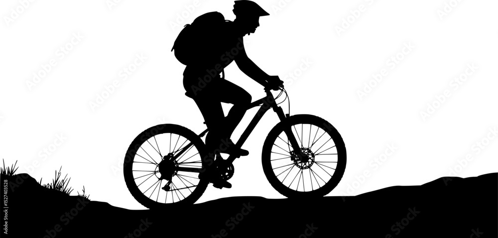 Fototapeta premium Silhouette of a mountain biker riding on uneven terrain, with a backpack and helmet